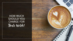 Text: Pricing: How much should you charge for your work? Background: Wooden table top with coffee, notebook and computer keyboard